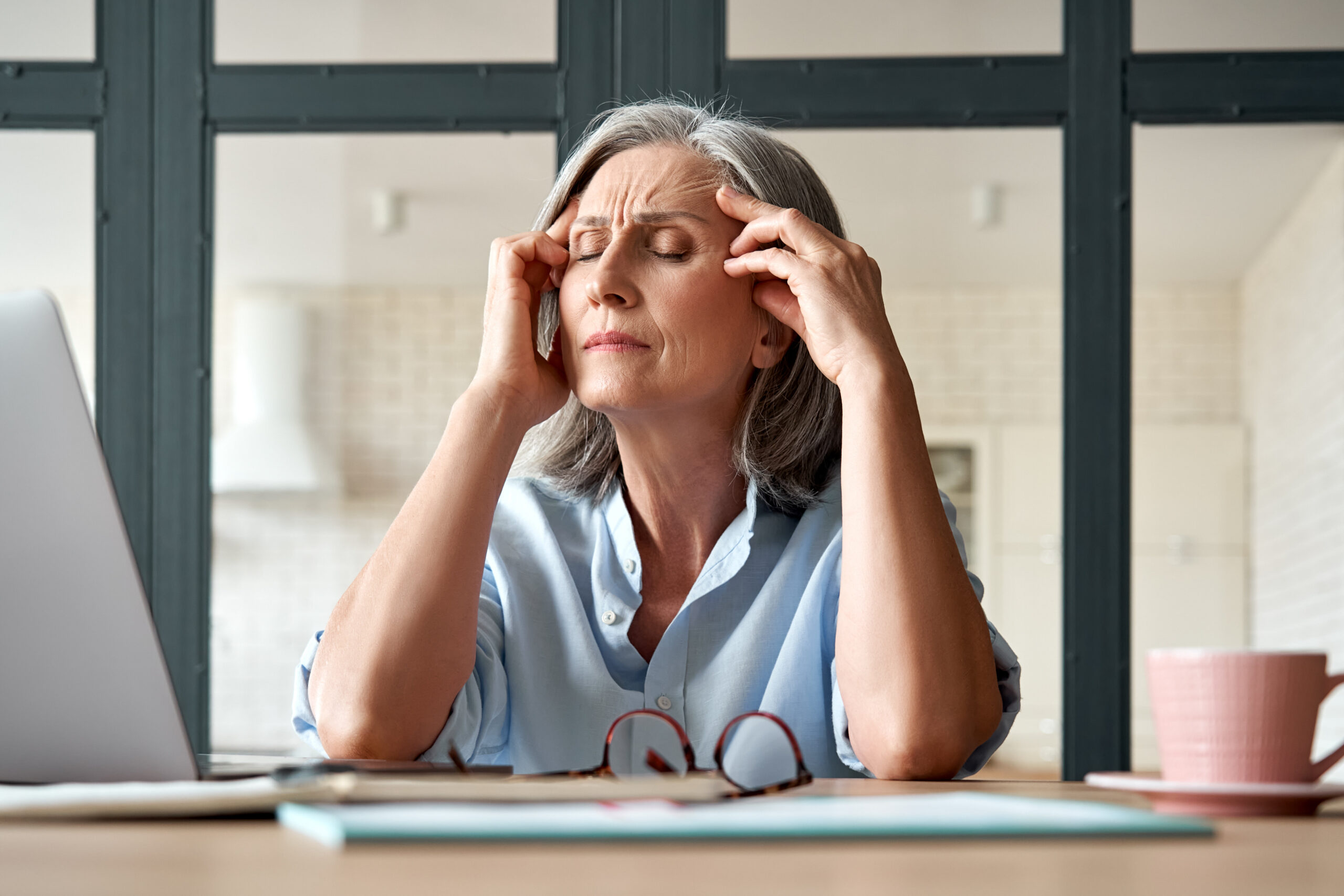 A woman struggles with a headache