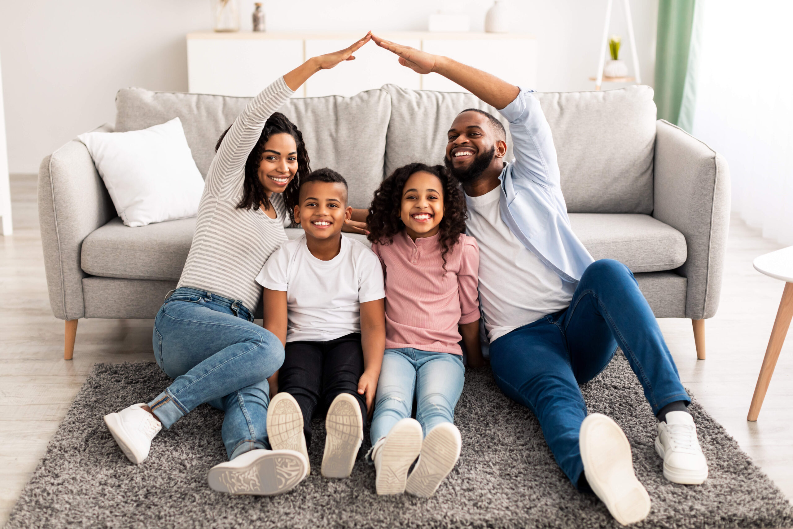 A happy family poses in their living room