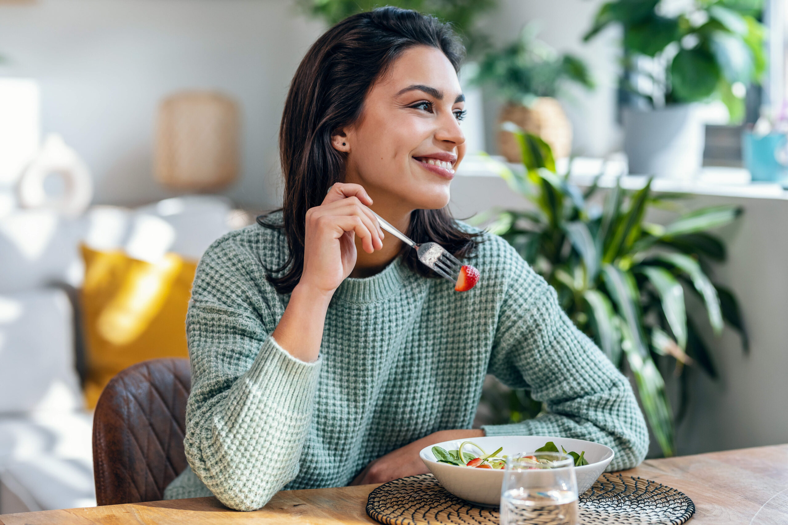 A woman eats a healthy meal