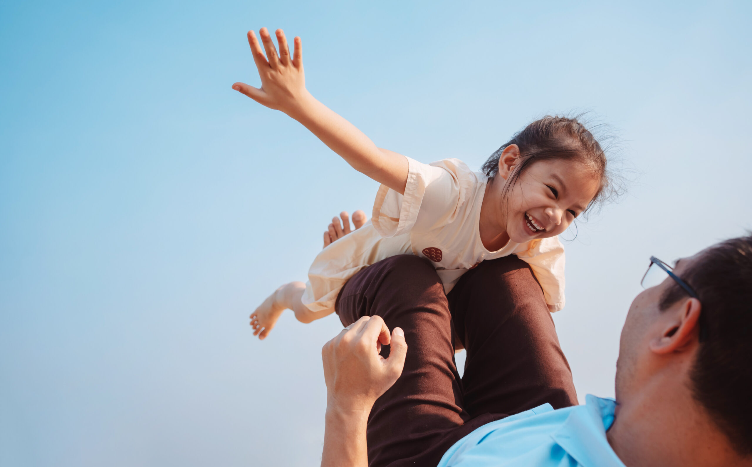 A dad plays with his daughter